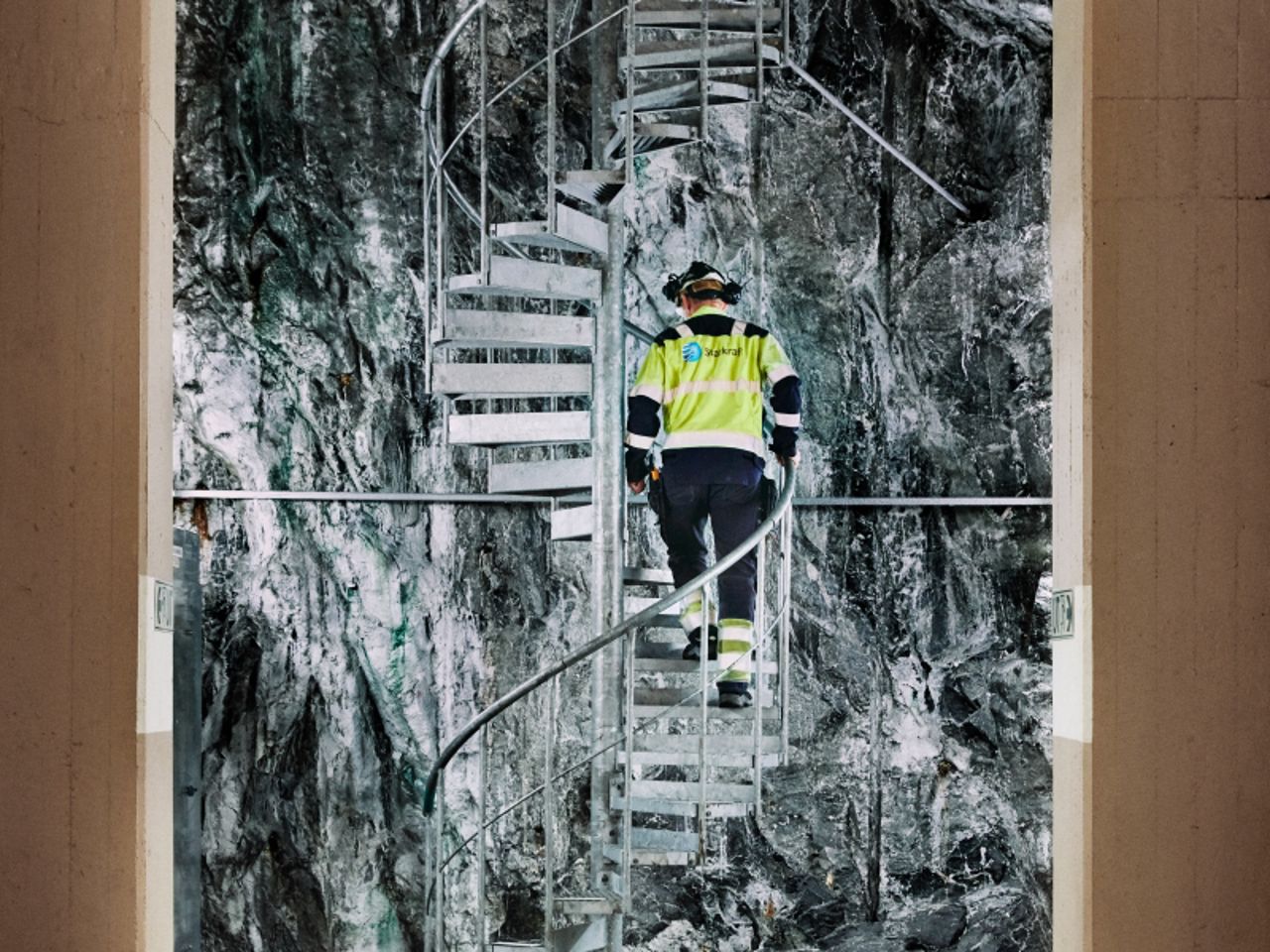 Mann geht Treppen im Kraftwerk hinauf