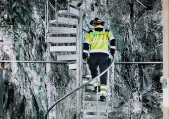 Statkraft employee walking up stairs in hydropower plant